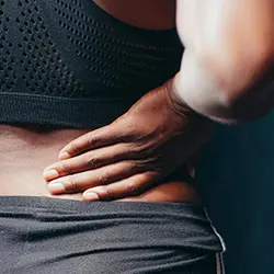 Therapist providing hands-on back pain treatment to support patient recovery and mobility